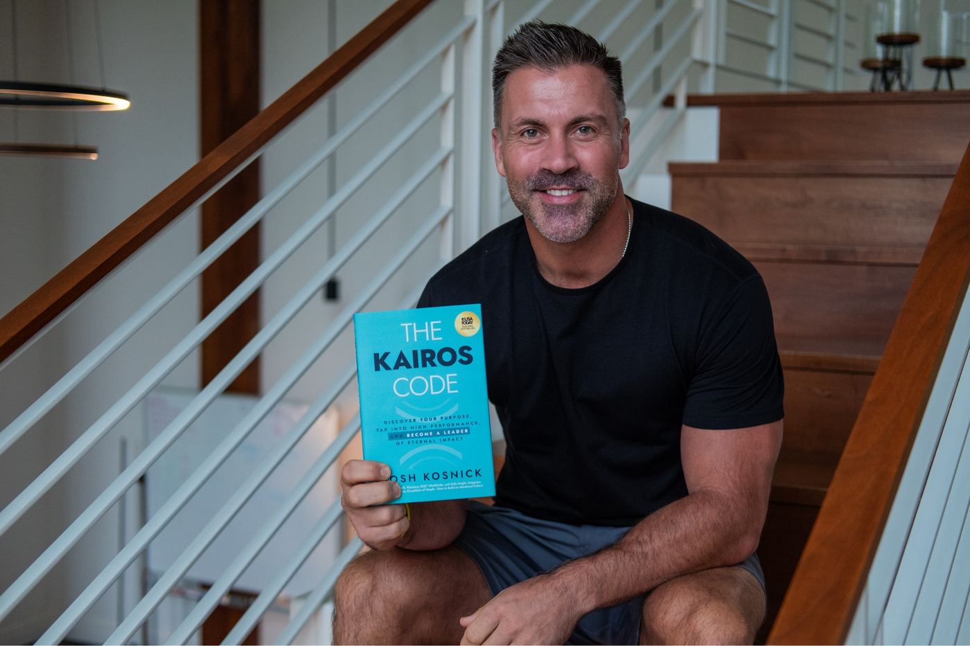 Author portrait holding a book — Sonder Advisory brand and editorial photography